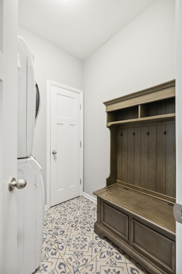 mudroom with stacked washer / dryer