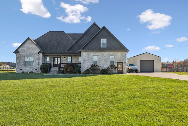 craftsman-style house with an outbuilding, a front lawn, and a garage