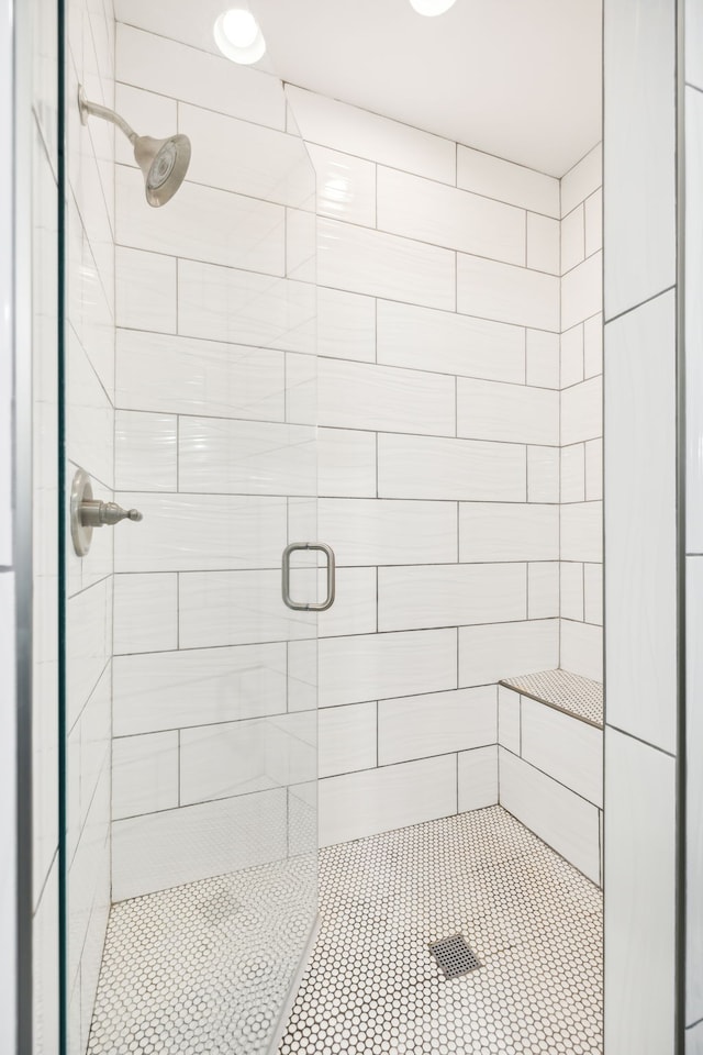 bathroom featuring a shower with shower door