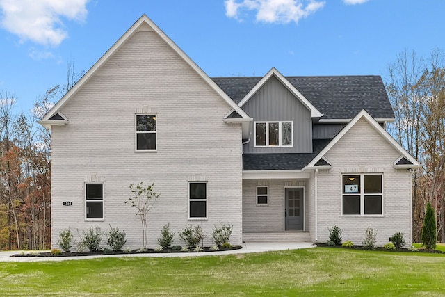 rear view of property with a yard