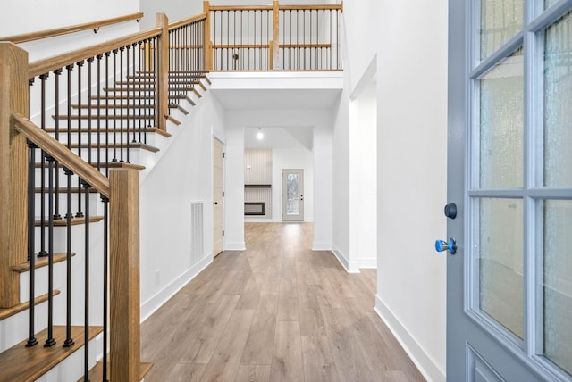 entrance foyer with light hardwood / wood-style flooring and a high ceiling