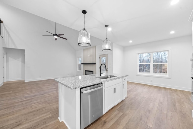 kitchen with sink, white cabinetry, light stone counters, a center island with sink, and dishwasher