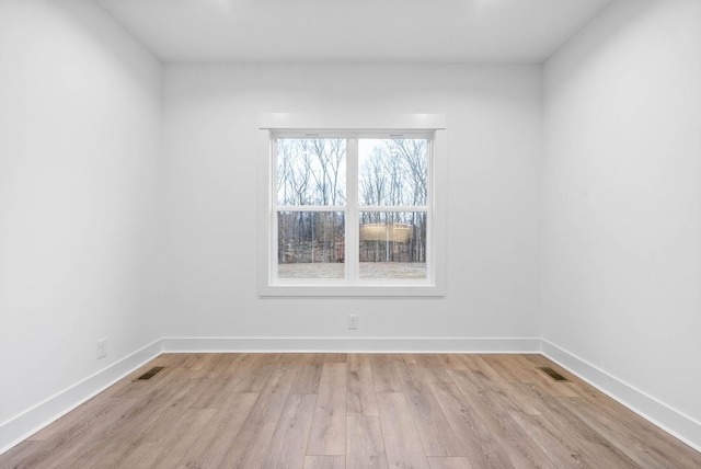 spare room featuring light wood-type flooring