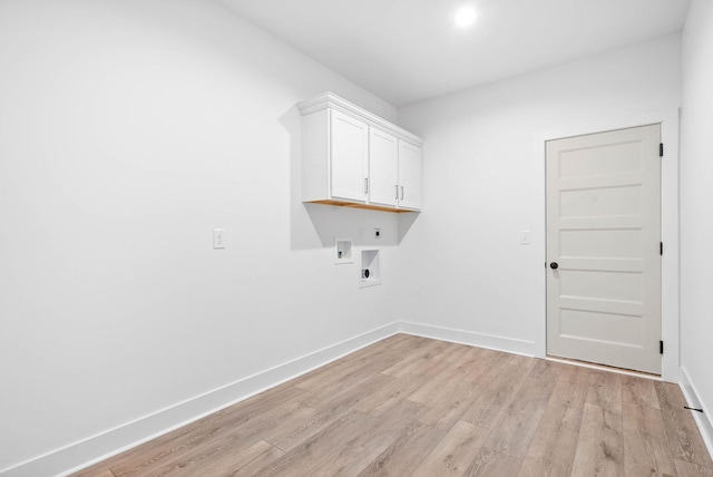 laundry area with washer hookup, cabinets, hookup for an electric dryer, and light wood-type flooring