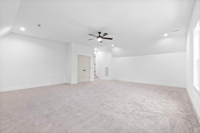 additional living space with light carpet, vaulted ceiling, and ceiling fan