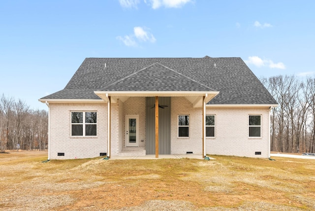 rear view of property featuring ceiling fan, a yard, and a patio area