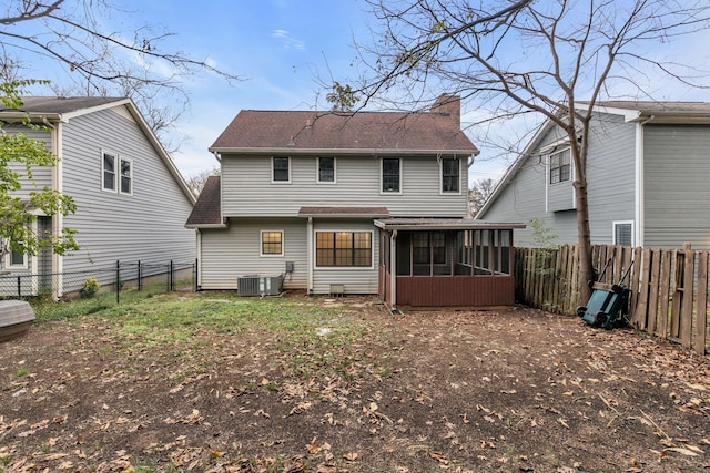 back of property featuring central AC and a sunroom