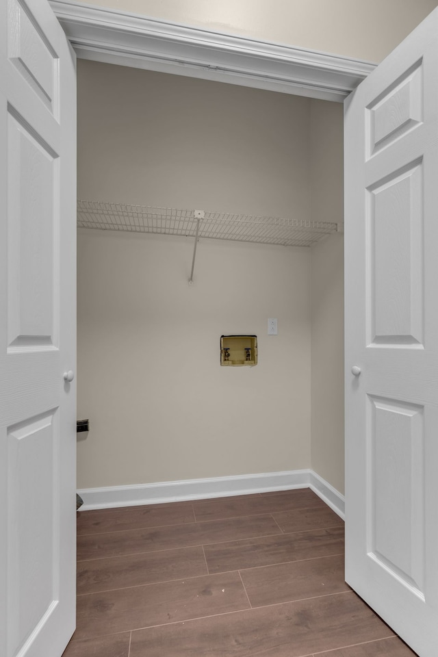 washroom with dark hardwood / wood-style floors and hookup for a washing machine