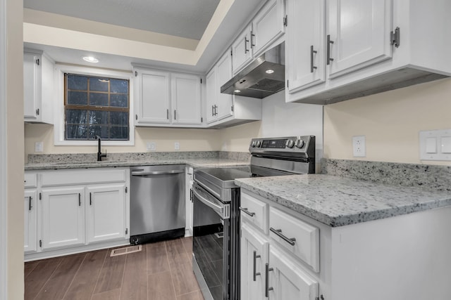 kitchen featuring sink, dark hardwood / wood-style flooring, white cabinetry, and stainless steel appliances