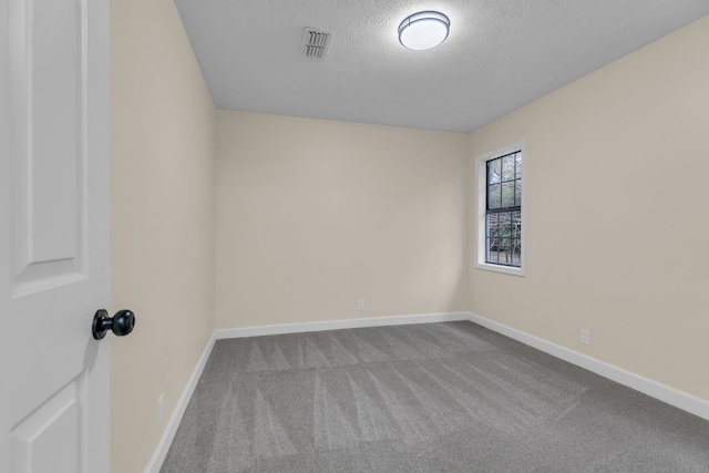 unfurnished room featuring carpet floors and a textured ceiling