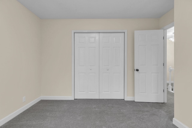 unfurnished bedroom with carpet and a closet