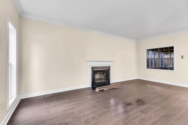 unfurnished living room with crown molding and dark hardwood / wood-style floors