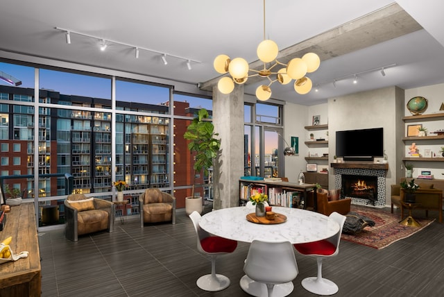 dining room featuring a wall of windows and a tile fireplace