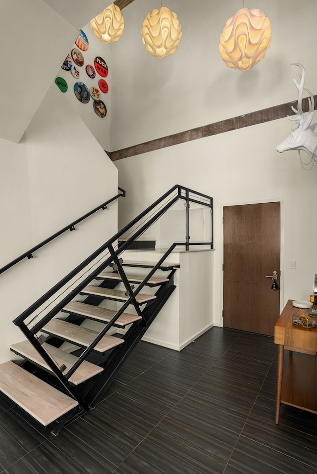 stairway featuring tile patterned flooring