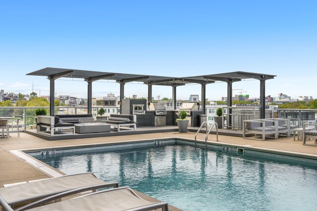 view of pool featuring a patio and exterior kitchen