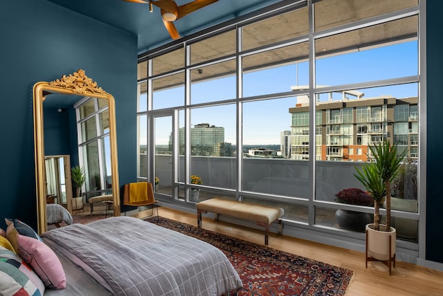 bedroom with hardwood / wood-style floors and a towering ceiling