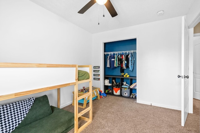 bedroom featuring carpet, ceiling fan, and a closet