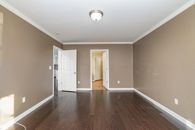 spare room featuring crown molding and dark wood-type flooring