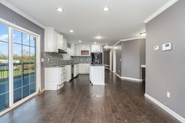 kitchen with black refrigerator, dark hardwood / wood-style flooring, crown molding, white cabinets, and a kitchen island