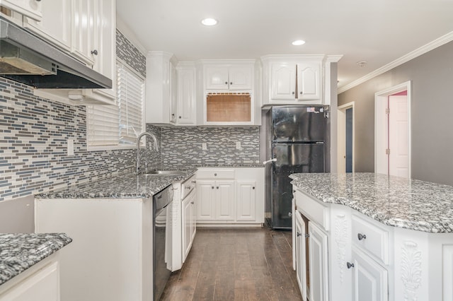 kitchen with sink, black fridge, dark hardwood / wood-style floors, stone countertops, and white cabinets