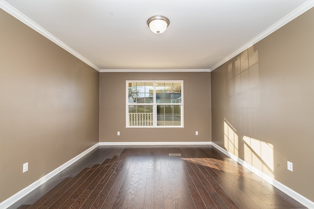 spare room featuring dark hardwood / wood-style floors and ornamental molding