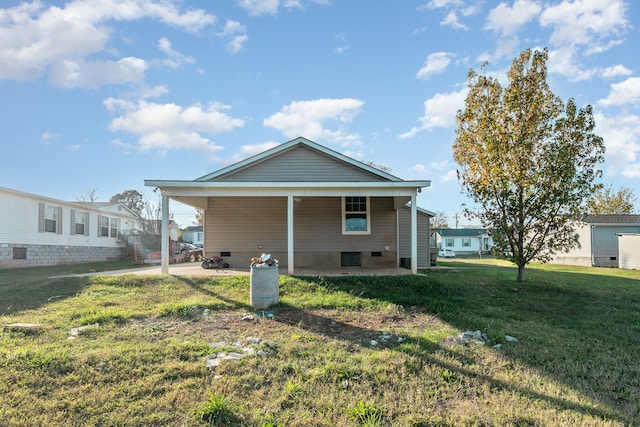 rear view of house featuring a lawn