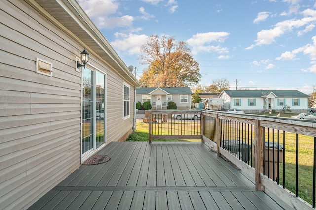 wooden deck featuring a lawn