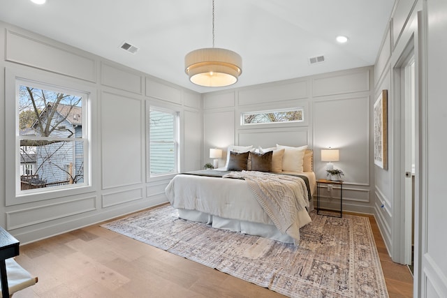 bedroom featuring vaulted ceiling and light hardwood / wood-style flooring