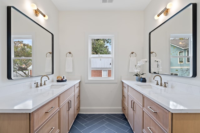 bathroom featuring tile patterned floors, vanity, and a healthy amount of sunlight