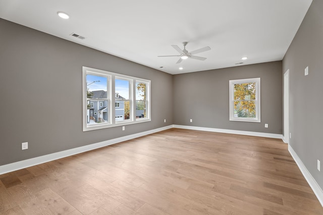 spare room with light hardwood / wood-style flooring, plenty of natural light, and ceiling fan