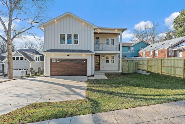 view of front of home with a balcony, a garage, and a front lawn