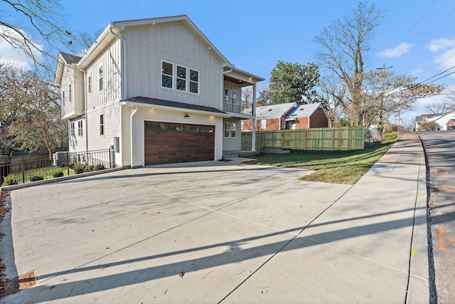 view of home's exterior with a yard, a balcony, and a garage