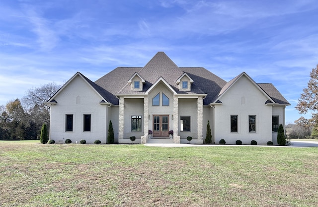 view of front of home with a front yard and french doors