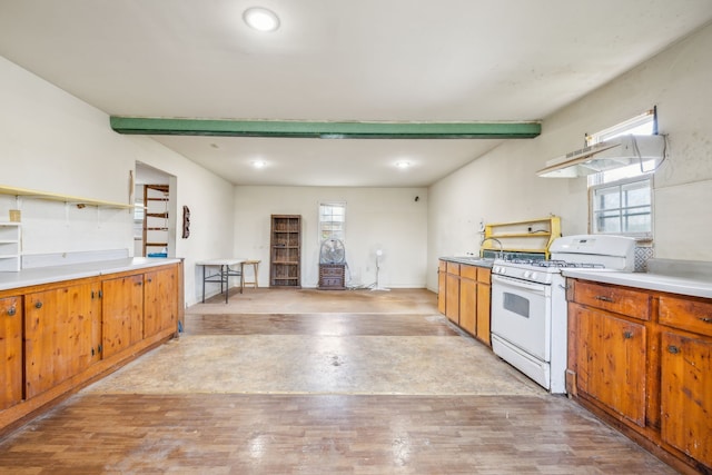 kitchen featuring white gas stove and light wood-type flooring