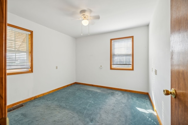 spare room featuring ceiling fan and carpet floors