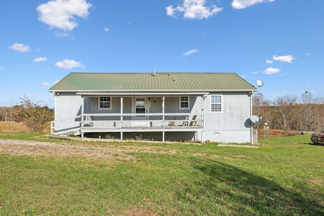 back of property with a porch and a yard