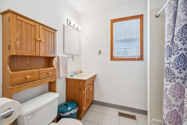 bathroom featuring tile patterned flooring, a shower with curtain, vanity, and toilet