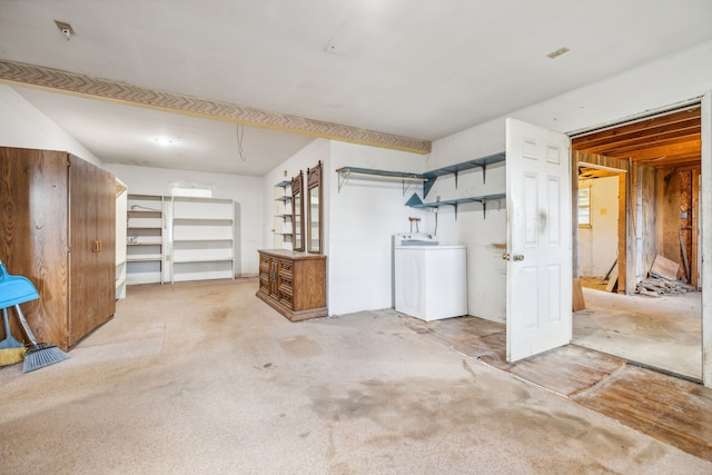 basement with washer / clothes dryer and light colored carpet