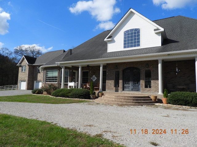 view of front of property featuring a porch and a garage