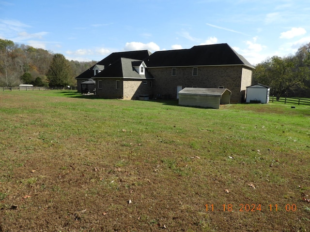 view of property exterior with a lawn and a storage unit