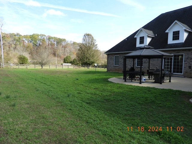 view of yard featuring a gazebo and a patio area