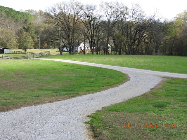 view of property's community featuring a yard and a rural view