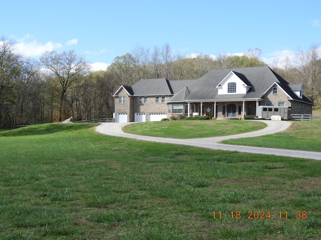 view of front of home with a front yard, a porch, and a garage