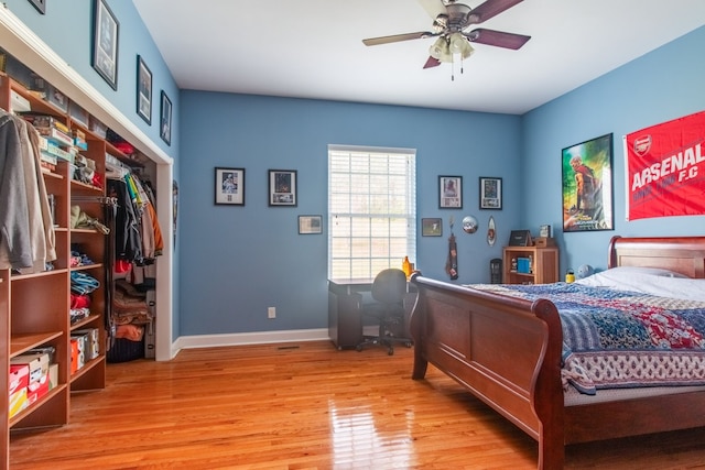 bedroom with light hardwood / wood-style floors, a closet, and ceiling fan