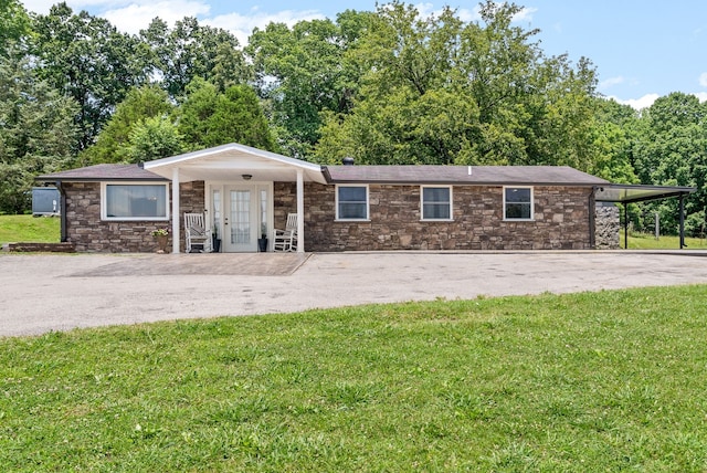 ranch-style home with a front yard and a carport