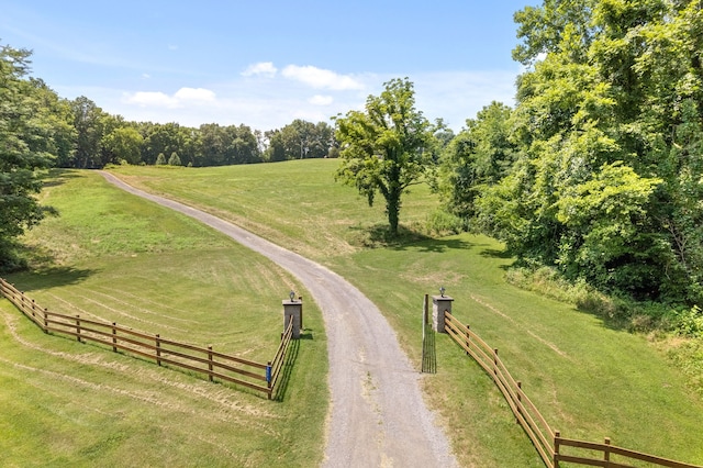 view of property's community with a yard and a rural view