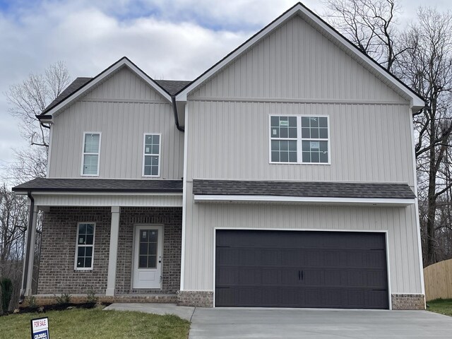 view of front facade with a porch and a garage