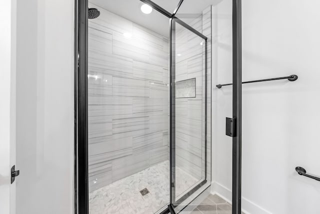 bathroom with a shower with door