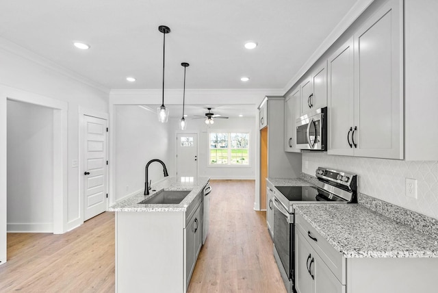 6 Charleston Cv, Clarksville, TN 37043 - kitchen with stainless steel appliances, ornamental molding, light wood-type flooring, decorative backsplash, and gray cabinetry