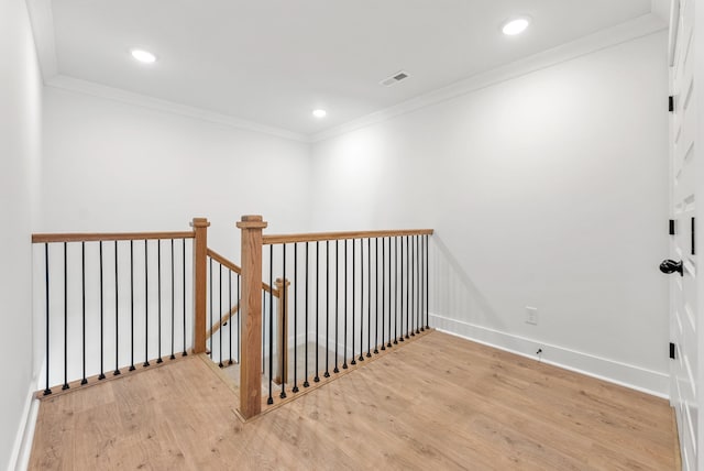 interior space featuring hardwood / wood-style flooring and ornamental molding